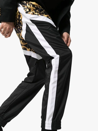 Shop Versace Panelled Baroque Print Track Pants In Red