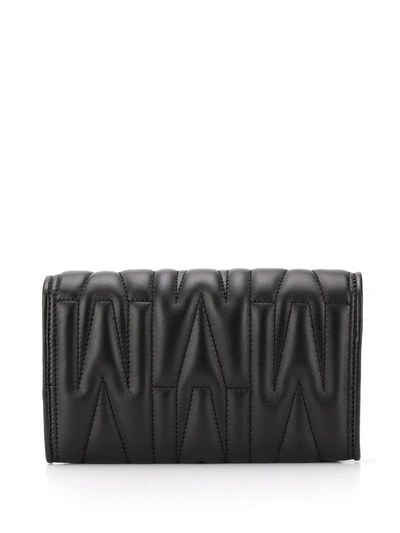 Shop Moschino Monogram-quilted Clutch Bag In Black
