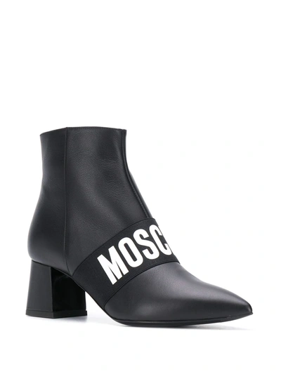 Shop Moschino Logo Band Ankle Boots In Black