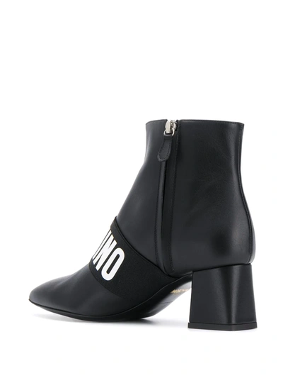 Shop Moschino Logo Band Ankle Boots In Black