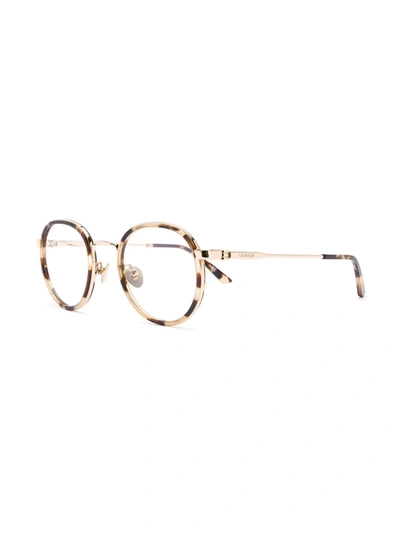 Shop Calvin Klein Tortoiseshell Round-frame Glasses In Neutrals
