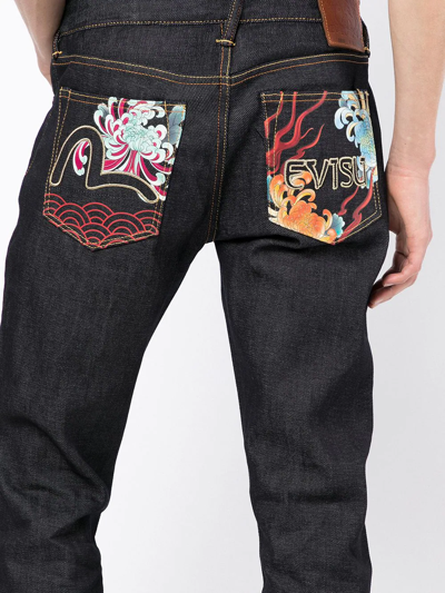 Shop Evisu Contrasting-panel Jeans In Blau