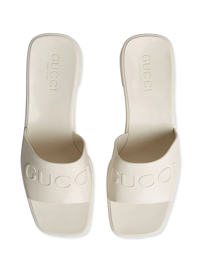 Shop Gucci Logo Embossed Sandals In White