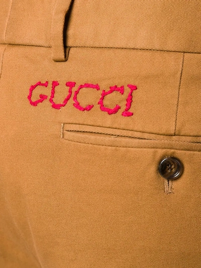 Shop Gucci Logo Embroidered Chino Trousers In Brown