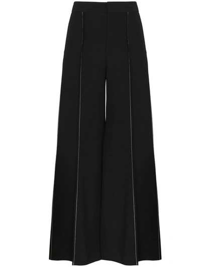 Shop Marni Contrast-stitch Flared Trousers In Black