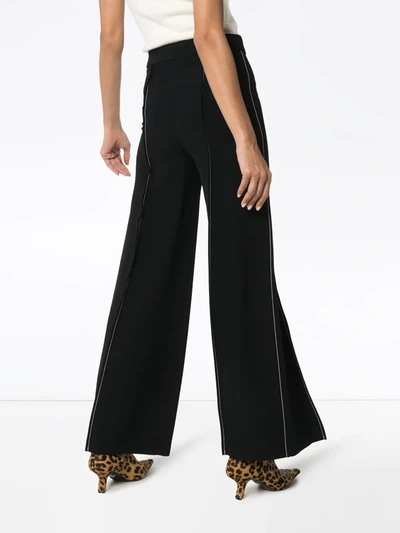 Shop Marni Contrast-stitch Flared Trousers In Black