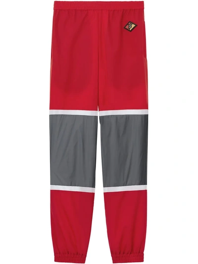 Shop Burberry Logo Graphic Striped Nylon Trackpants In Red