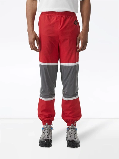 Shop Burberry Logo Graphic Striped Nylon Trackpants In Red