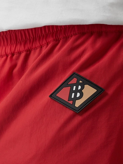 Shop Burberry Logo Graphic Striped Nylon Trackpants In Red