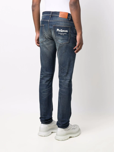 Shop Alexander Mcqueen Mcqueen Graffiti Denim Jeans In Blue