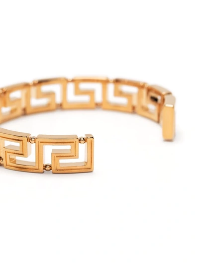 Shop Versace Greca Key Cuff Bracelet In 金色