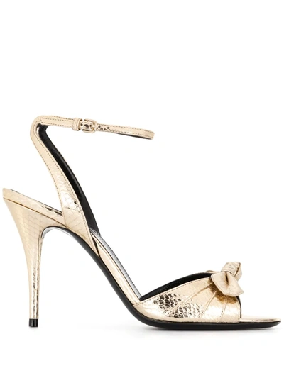 Shop Saint Laurent Bow-detail Sandals In Gold