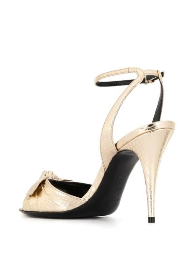 Shop Saint Laurent Bow-detail Sandals In Gold