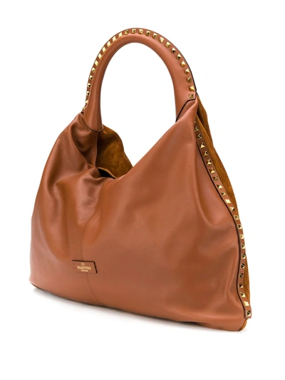 Shop Valentino Rockstud Shoulder Bag In Brown