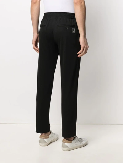 Shop Emporio Armani Pressed-crease Elasticated-waist Trousers In Black