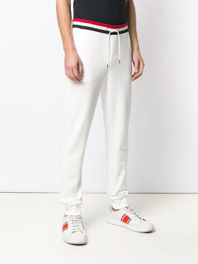 Shop Moncler Striped Waistband Trousers In White