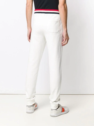 Shop Moncler Striped Waistband Trousers In White