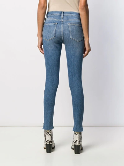 Shop Frame High Rise Skinny Jeans In Blue