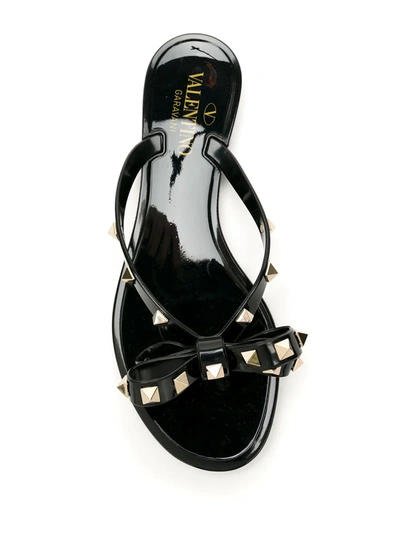 Shop Valentino Rockstud Thong Sandals In Black