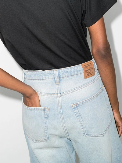 Shop Totême High-waisted Flared Jeans In Blue