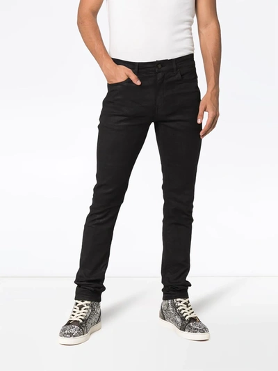 Shop Saint Laurent Coated Skinny Jeans In Black