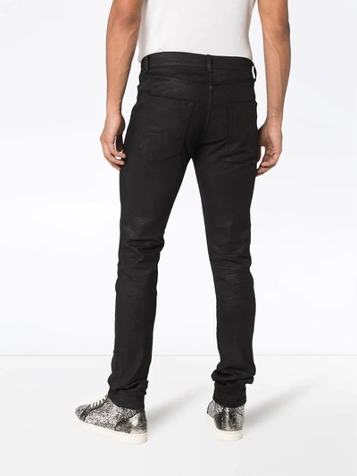 Shop Saint Laurent Coated Skinny Jeans In Black