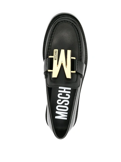 Shop Moschino M Plaque Loafers In Black