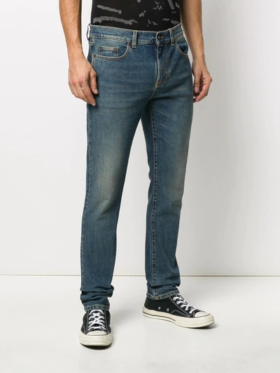 Shop Saint Laurent Faded-effect Blue Jeans