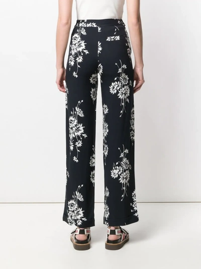 Shop Mcq By Alexander Mcqueen Floral Printed Trousers In Black