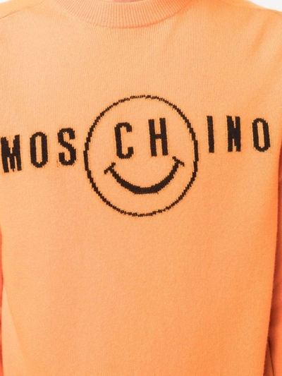 Shop Moschino Smiley Face Logo Jumper In 橘色