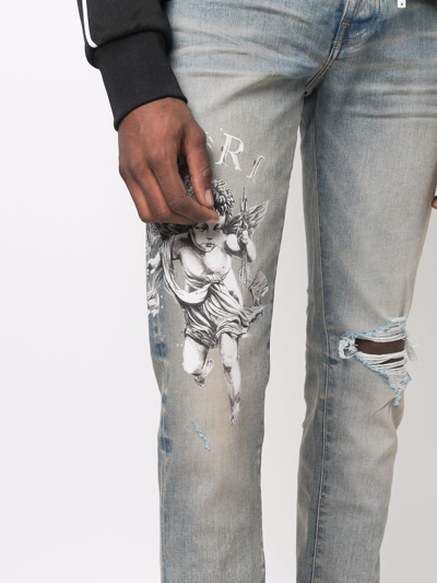 Amiri Cherub Skinny-fit Distressed Printed Jeans In Blue | ModeSens