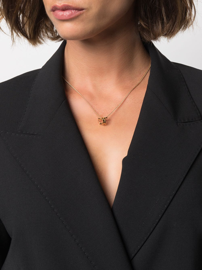 Shop Saint Laurent Monogram Twist Pendant Necklace In Gold
