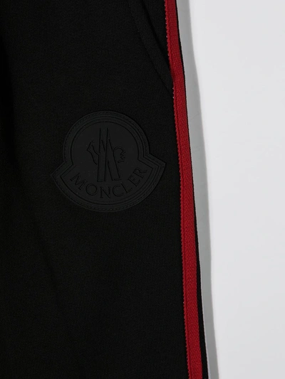 Shop Moncler Side Stripe Trousers In Black