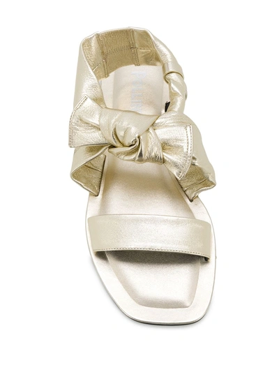 Shop Pollini Bow Detail Flat Sandals In Gold