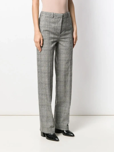 Shop Versace High-rise Check Trousers In Black