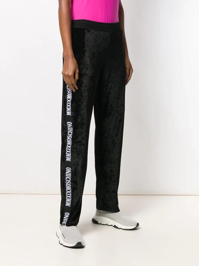 Shop Moschino Logo Stripe Track Pants In Black