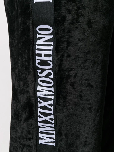 Shop Moschino Logo Stripe Track Pants In Black