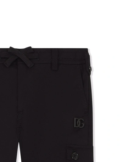 Shop Dolce & Gabbana Embossed Logo Cargo Trousers In Black