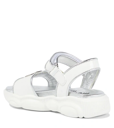 Shop Moschino Logo Leather Sandals In White Silver