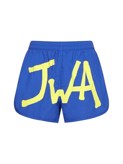 Shop Jw Anderson Logo Printed Curved Hem Swim Shorts In Blue