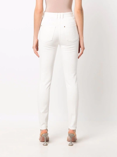 Shop Balmain Logo-buttons Skinny Jeans In Weiss