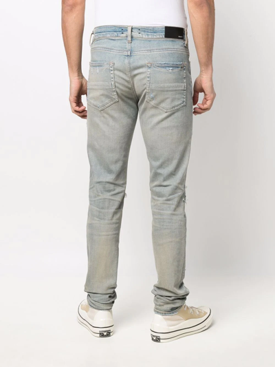 Shop Amiri Distressed-finish Ripped Skinny Jeans In Blue