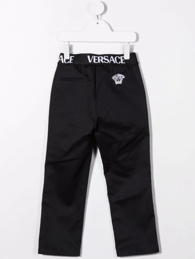 Shop Versace Logo-waistband Trousers In Blue