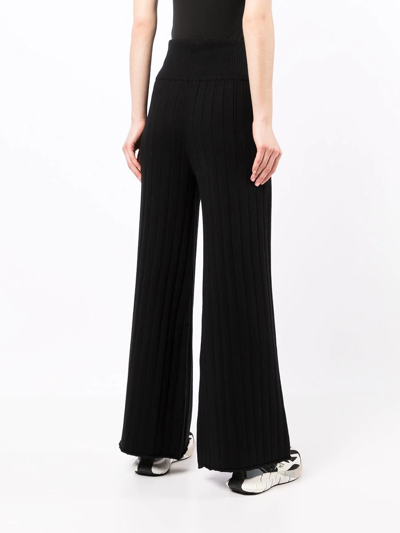 Shop Onefifteen Ribbed Knit Flared Trousers In Schwarz