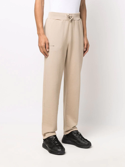 Alyx Logo-print Relaxed-fit Tapered Cotton-jersey Jogging Bottoms In Nude