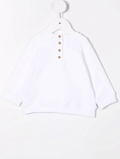 Shop Balmain Embossed Logo Sweatshirt In White