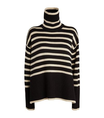 Shop Totême Wool-cotton Striped Sweater In Black