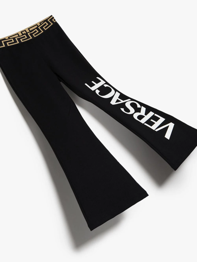 Shop Versace Greca-waistband Logo Trousers In Black