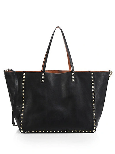 Shop Valentino Reversible Studded Leather Tote In Black-cognac