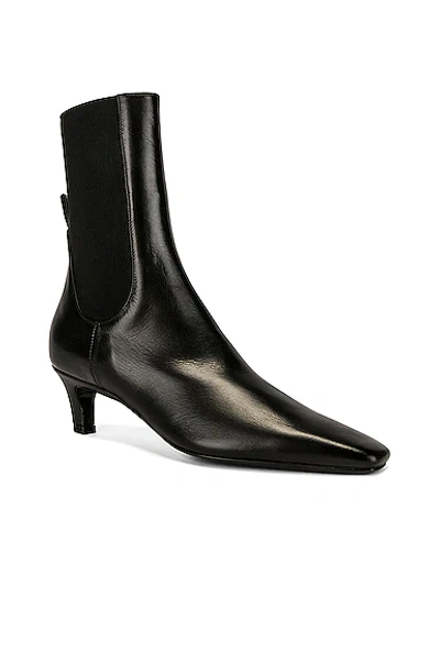 Shop Totême The Mid Heel Boot In Black